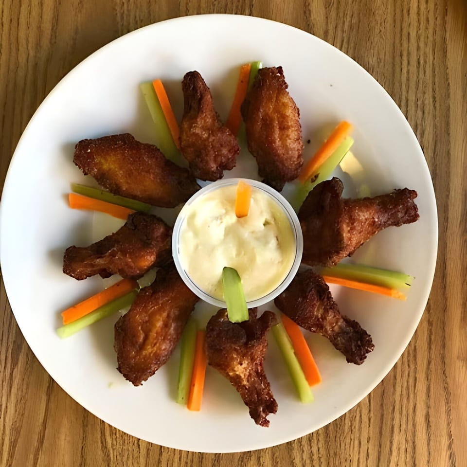 Bella Luna Pizza's crispy chicken wings, with celery, carrots, and a side of ranch dressing.